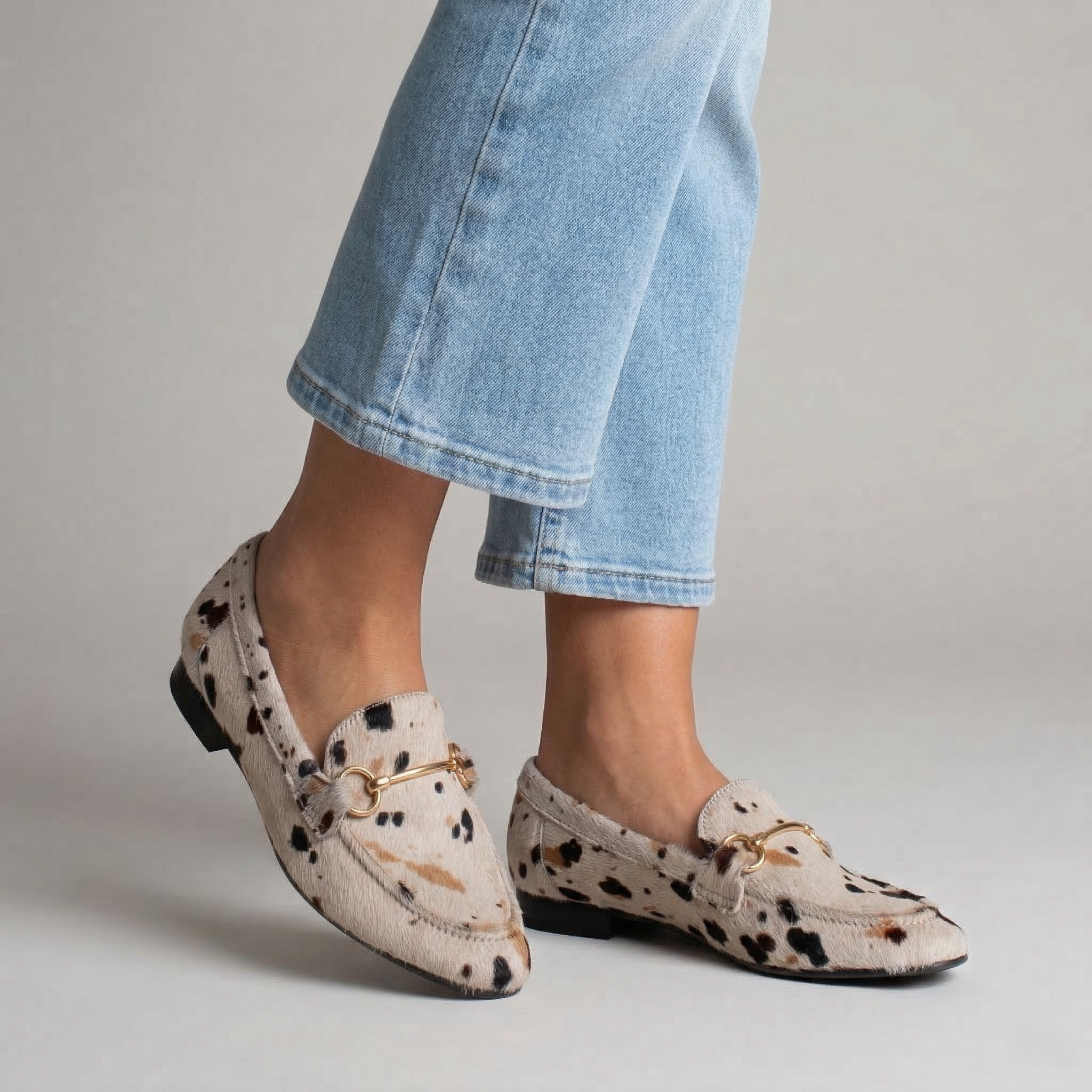 Cow-print pony-skin loafers with a gold clasp