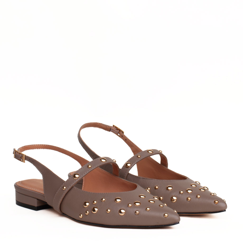 Chanel flat shoes in taupe-coloured leather with studs, a strap and gold-coloured detailing.