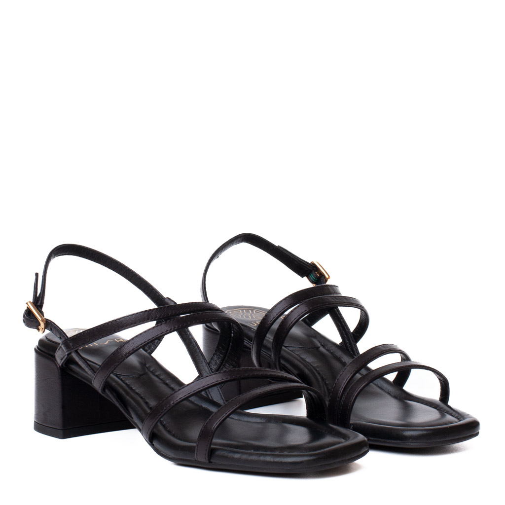 Black Kalma sandals by Unisa, featuring a wide heel and made from black leather with criss-cross straps.